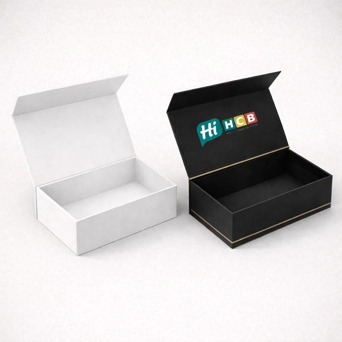 A pair of open rectangular magnetic gift boxes in matte white and black with branding- class=